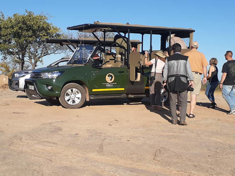 From Malelane: Kruger National Park Full-Day Safari - Open 4x4 with tiered seating, plus radios for better spotting