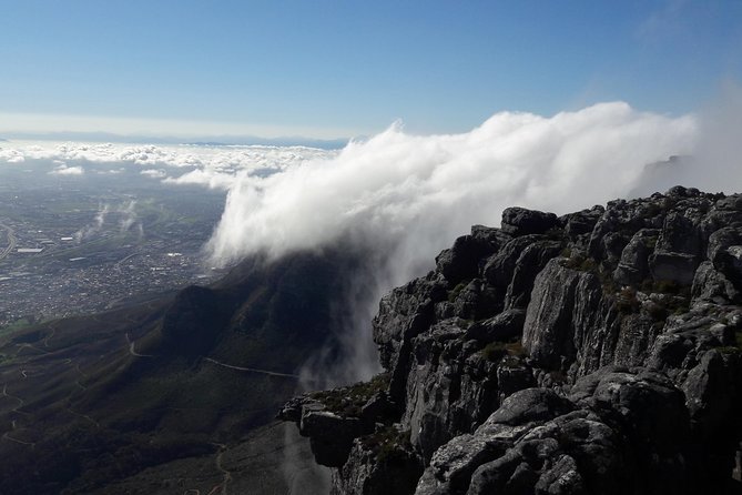 Hiking Table Mountain via Kasteels Poort Morning Hike - Getting started at Kloof Neck, with the mountain doing the shading