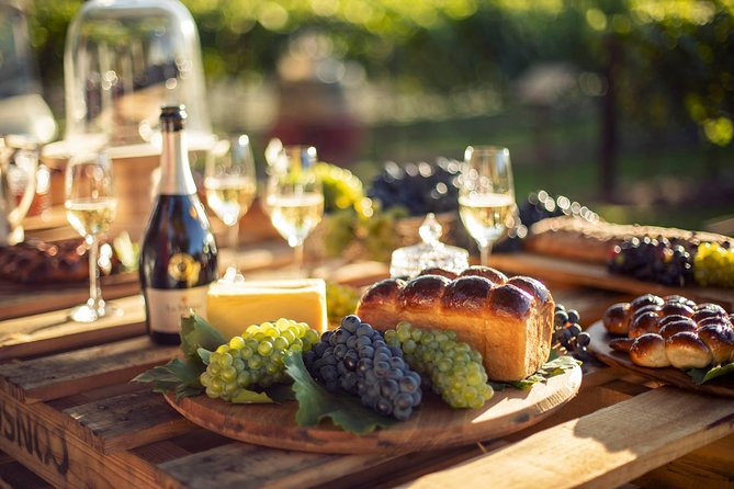 Luxury Wine Tour with Lunch - Stop 4 in Stellenbosch: wine, a platter, and mountain views