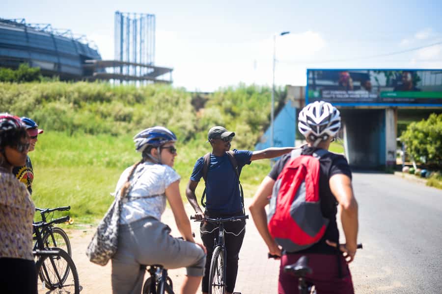 Soweto: Guided Bicycle Tour with Lunch - Riding past Tutu House on Vilakazi Street